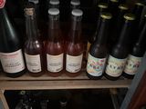 many bottles of beer sitting on a shelf in a room