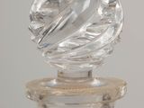 a glass bottle with a glass top on a table
