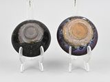 pair of black and gold earrings with a black and gold disc