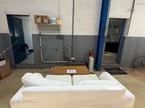 a white couch in the middle of a large room