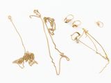 a lot of gold jewelry on a white surface