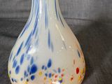 a white vase with a blue and red design on it