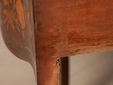 a small wooden table with a floral design on it