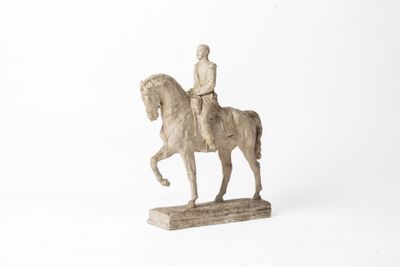 figurine of a man riding a horse on a white background