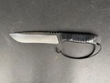 a knife on a table with a cord attached to it