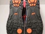 the soles of a pair of black and orange running shoes