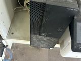 a computer sitting on top of a desk next to a monitor