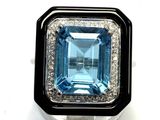 an image of a ring with a blue topaz stone surrounded by white and black diamonds
