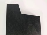 a close up of a piece of black paper on a white surface