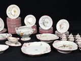 many different types of plates and bowls on the table