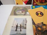 a lot of records on a table with a picture of a man shaking hands