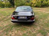 a car that is parked in the grass in the yard