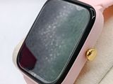 a pink apple watch sitting on top of a display