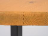 a close up of a wooden table with holes in it