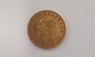 an image of a gold coin sitting on top of a white surface
