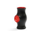 a black vase with a red top on a white surface
