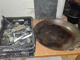 Les casseroles et les poêles sont posées sur une table, avec une poêle sale