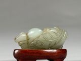 chinese carved jade figurine of a turtle on a wooden stand