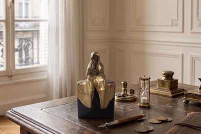 a wooden table with a clock and other items on it