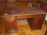 a wooden desk with a marble top in a room