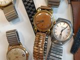a lot of watches that are sitting on a table