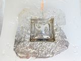 a silver object with a picture of an elephant on it