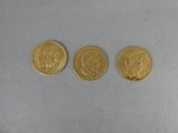 three gold sovereigns, one of which is a sovereign and one of which is a sovereign
