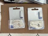 two boxes with white items in them on a table