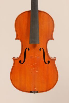 an old violin with a bow hanging from it ' s back