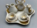 a tray with a tea set on it on a table
