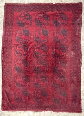 a red and black rug on a white floor