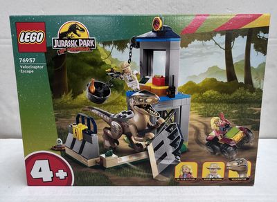 the box is open to show the contents of the lego jurassic park set