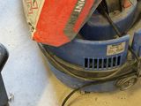 a blue machine that is sitting on the floor