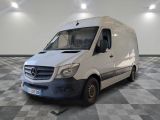 a white van parked in a room with checkered flooring