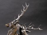 bronze sculpture of two stagss fighting with each other