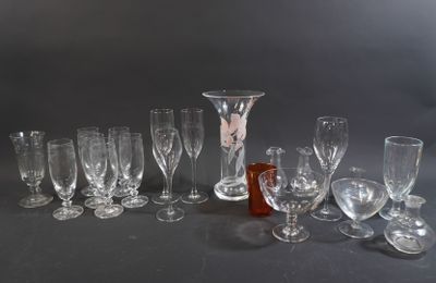 a lot of wine glasses and a bottle on the table