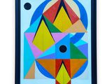 un tableau représentant un motif géométrique coloré, dans un cadre noir
