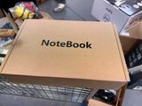 a cardboard box with a note book on top of it