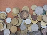 a pile of coins sitting on a table with a coin on top of it