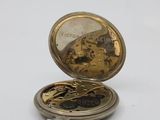 a gold pocket watch with a chain on it