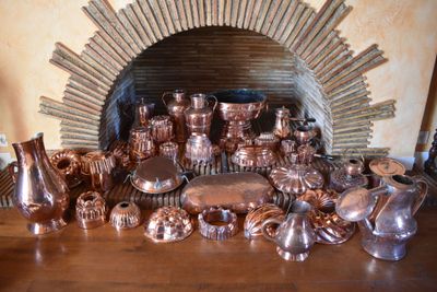many different types of copperware on the table