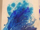 two paintings of blue and purple paint on a piece of paper