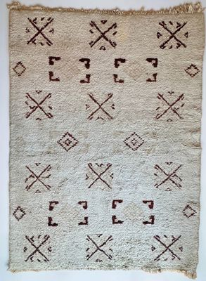 a white and brown rug with crosses and arrows on it
