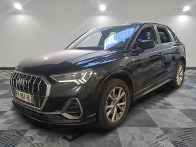a black audi qx parked in a showroom with a checkered floor