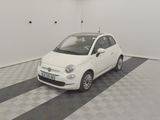 a small white car that is parked in a room