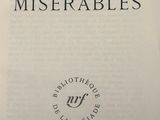 an open book with the title les miserables written on it
