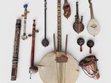 many different musical instruments arranged together on a white surface