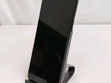 a cell phone on a stand on a white surface