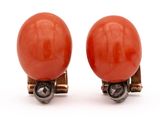 pair of red coral and silver earrings on a white background