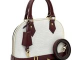 a white and maroon handbag with a belt on a white background